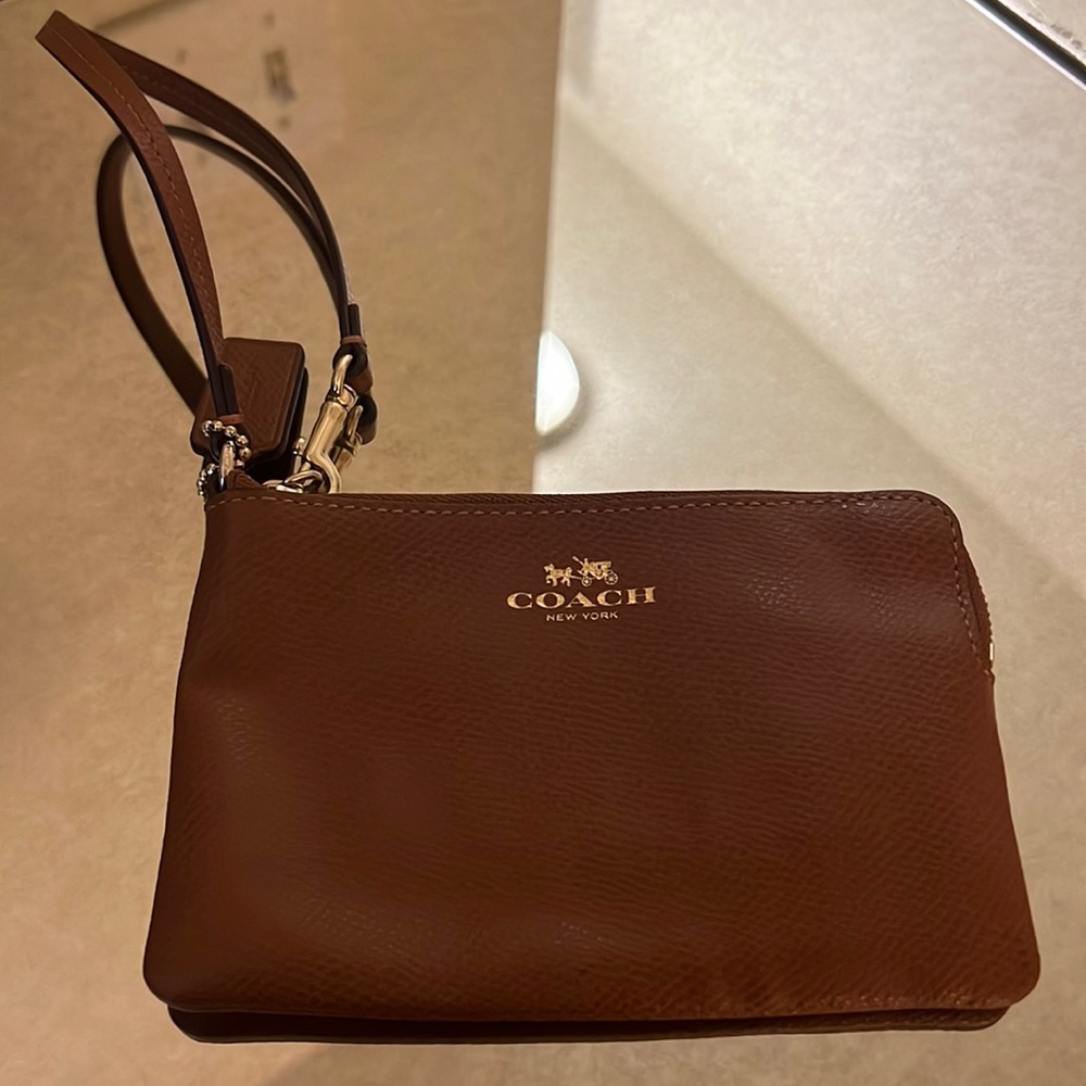 Coach brown and gold wristlet. In good condition.
